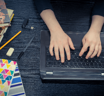 Image of a person working on a laptop for online learning