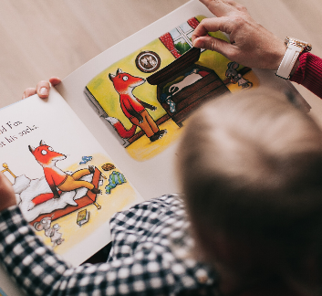 Child reading a picture book image