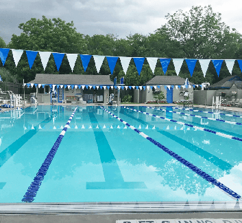 clear swimming pool with diving board in the background