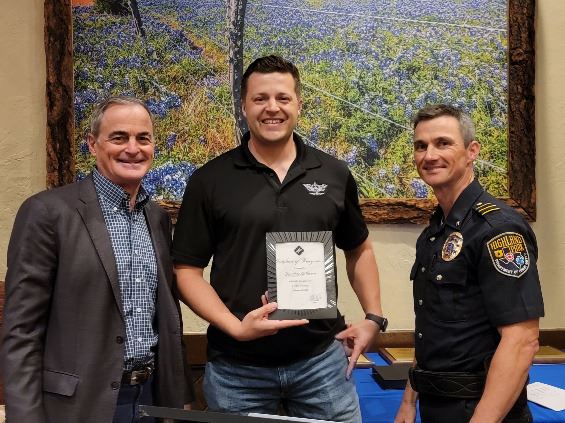 Three people grouped together, smiling at the camera