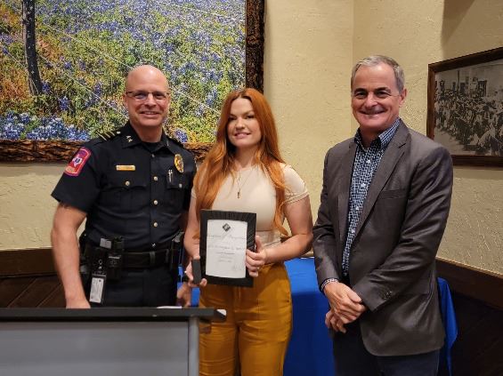 Three people grouped together, smiling at the camera
