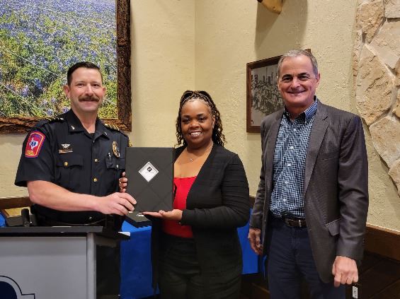 Three people grouped together, smiling at the camera